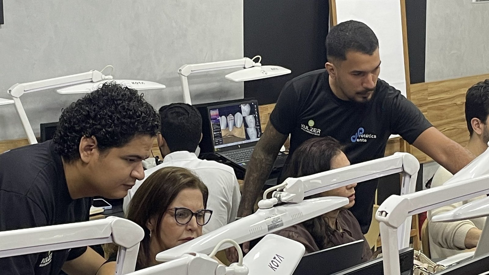 Instrutor circulando pela sala técnica acompanhando os alunos